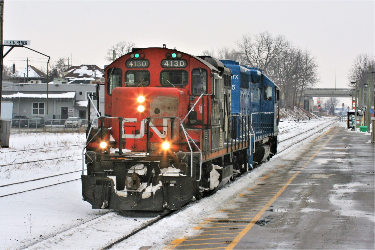 CN train L540 with CN GP9RM 4130 and GMTX 2255 are just light units as they roll west by the Kitchener VIA Rail station and former GEXR office. The units were heading for the Huron Park Spur in Kitchener, where they would make their way to the interchange with Canadian Pacific to lift cars. CN A431 had not run in several days from MacMillan yard, hence there were no cars for them to take to the CP interchange.