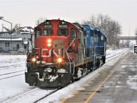 CN train L540 with CN GP9RM 4130 and GMTX 2255 are just light units as they roll west by the Kitchener VIA Rail station and former GEXR office. The units were heading for the Huron Park Spur in Kitchener, where they would make their way to the interchange with Canadian Pacific to lift cars. CN A431 had not run in several days from MacMillan yard, hence there were no cars for them to take to the CP interchange.