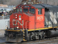 After seeing Steve's recent shot of CN 9675 at Guelph on the previous day's L540, I was reminded of a photograph I took of the same unit the following day as it switched the Kitchener yard during the morning. It was noted that the unit's former GO Transit heritage was coming through on the conductor's side, so here is a close-up of that, as the green paint of GO 708 can be seen above the window as well as on the bell.