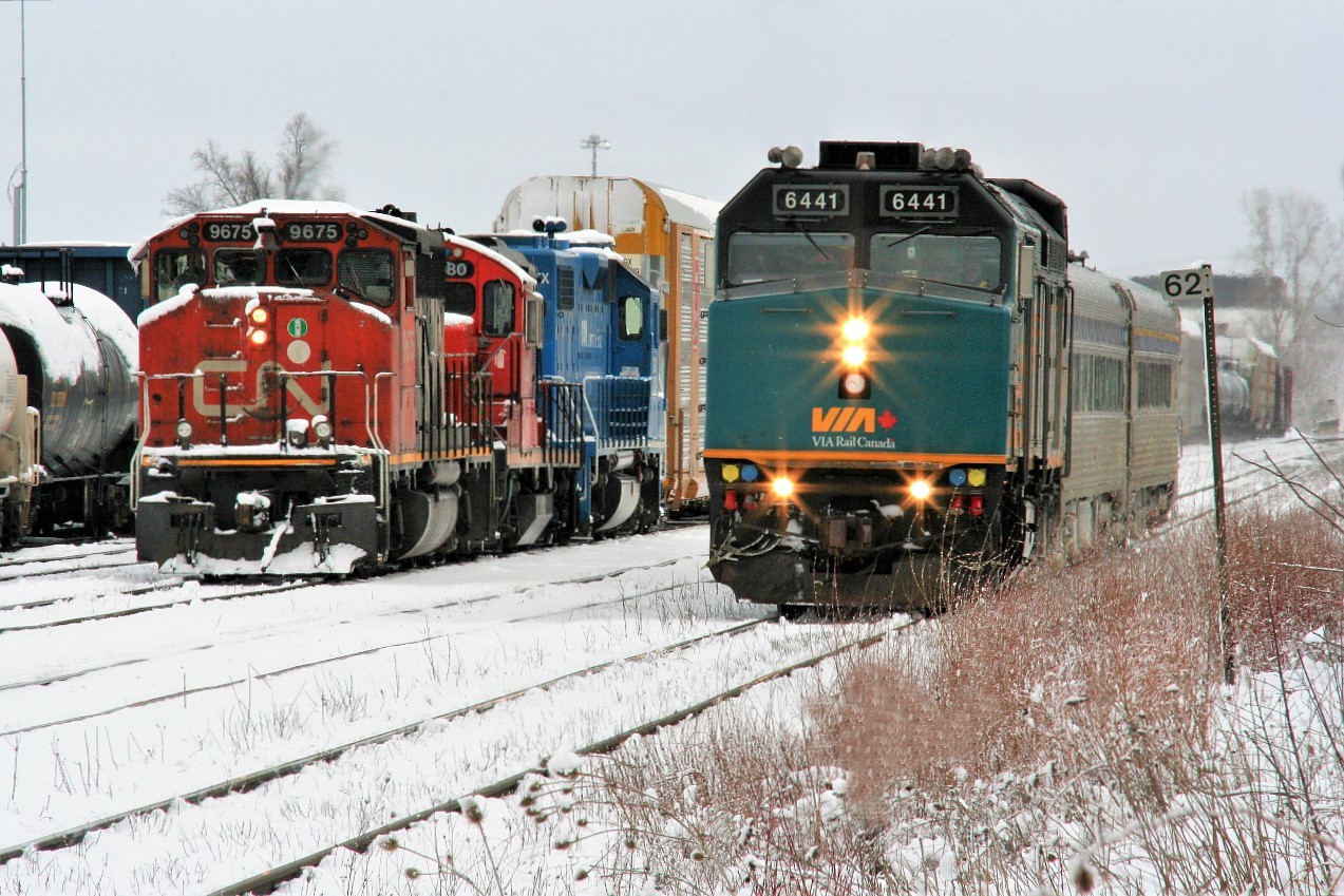 VIA Rail #85 with 6441 passes Mile 62 on the Guelph Subdivision as CN L568 builds its train for the Huron Park Spur at the Kitchener yard with 9675, 7080 and GMTX 2289.