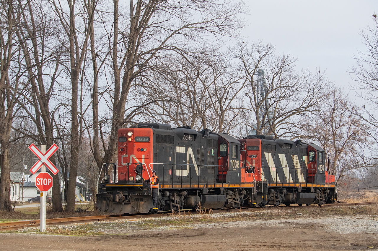 CN 514, with 7038 and 4130, has made the decent into Agris in Thamesville to lift two empties. It's quite the grade down off the Chatham Sub, and you can see the switch stand to the right of 4130. I'd also shot 4777 on the grade itself, back in May 2018. This particular 514 did not go to Blenheim, and also did not take any loads to Thamesville. Because their only work required using the north track on the Chatham Sub in Thamesville, it took them more than two hours to even move in Chatham. They're ordered for 0800, but didn't get moving until after 1000 on account of the two VIAs that come through Chatham on the Chatham Sub. Compounding my impression of the lack of a productive day, this train ran for the express purpose of lifting the two empties from Thamesville. After they lifted the empties, they pulled them across to the east side of Victoria Road (County Road 21), where they ran around the train for the return trip to Chatham. That was the extent of the day.

I'd long just assumed this vantage of 514 coming into Agris was private property - part of the Agris facility itself - so I had never shot here before. It turns out that it's actually a public road - Railway Line. Pays to go down the Google Maps rabbit hole sometimes.