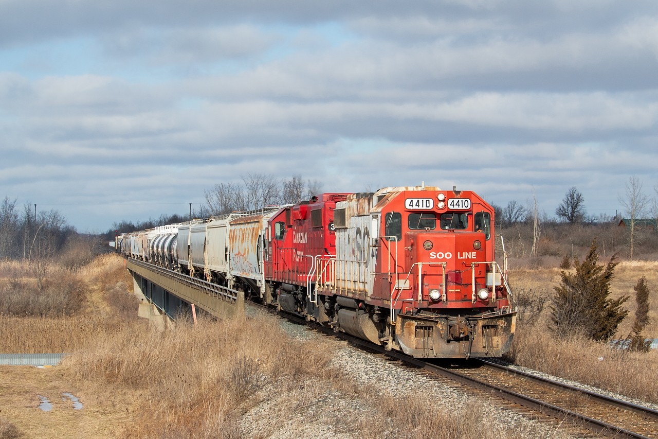 My family needed someone to run to the Niagara area today, so knowing 4410 was around I volunteered and added a generous amount of wiggle room to my travel time. I have a rough idea of a typical day for TE11 (switching Welland Yard, transfer run to Trillium at Feeder and CN at Southern Yard, and some more puttering around the yard), so I tried to time it such that I'd be there for the run back from interchange at CN Southern Yard. Pictured here, SOO 4410 leads CP TE11 on the CN Stamford Sub, over top of the CP Hamilton Sub on its way back to Welland Yard. You can see the tops of autoracks currently stored in Rusholme Siding at both bottom left and right. The tanks and hoppers in tow appear to all be for Innophos in Port Maitland, which CP TE21 visits twice a week on Tuesday and Friday nights (or Wednesday and Saturday mornings depending how you want to look at it). On this day they set off at Feeder and made no lift there, and brought seven or so tanks/hoppers from Innophos back to CN at Southern Yard and lifted the 20 or so pictured.