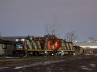 A couple of old workhorses idle away at London East, sitting next to Zubick's scrap yard. In the background, the BMO Centre provides a familiar site for those familiar with railfanning around London. <br><br>This was shot in the early evening hours, and once 435 yarded their train, 583 was not far behind it. When 583 made their set off, their power was tied onto the two GMD-1s for the evening's 584 to St. Thomas and back. The full complement of 584 power for this evening was GMTX 2695, CN 4774, CN 1444, and CN 1412.