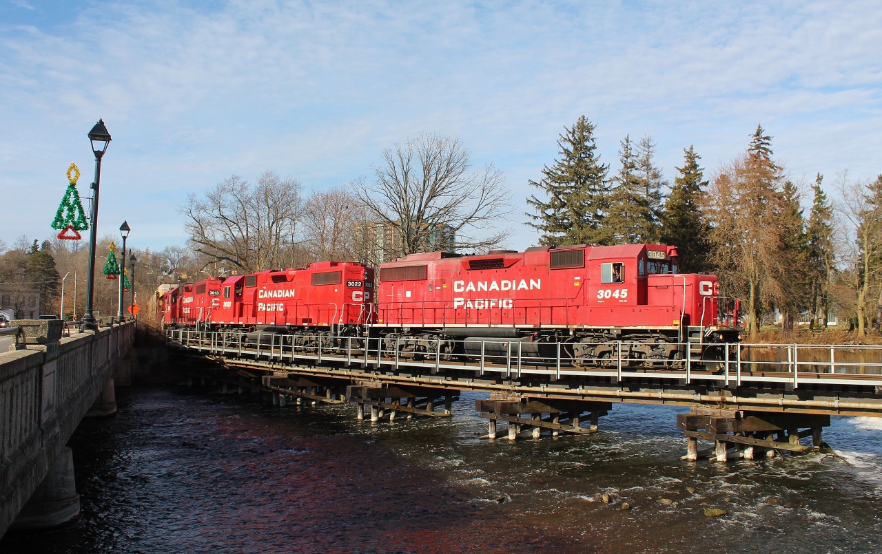 CP T-72 crosses the Speed River on their way back to Wolverton after working Hagey Yard all afternoon. There was a decent crowd out chasing this and another local in Cambridge and the crew seemed to be having just as much fun interacting with us as we were with them. The engineer can be seen giving a big wave and smile to the small crowd that had gathered here at this iconic photo location.