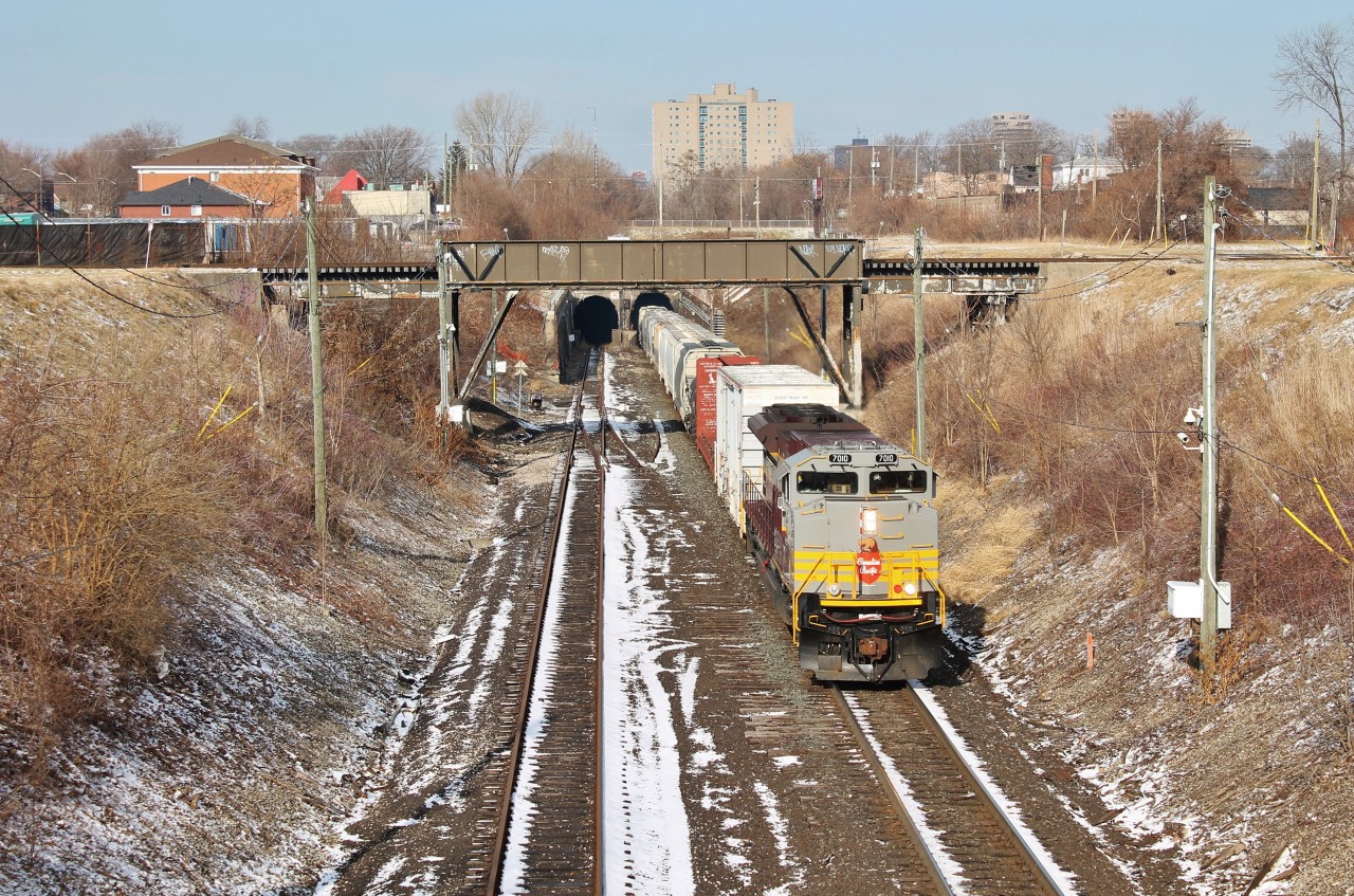 CP 140 exists the Detroit River rail tunnel on a beautiful New Years day afternoon with a pristine SD70ACU rebuild, decked out in CP's script heritage scheme.