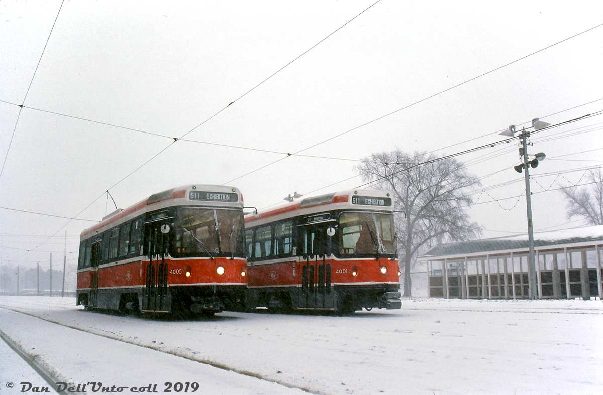 Sunday, December 29th 2019 marked the end of the CLRV streetcar era in Toronto, after over 40 years of prowling Toronto's streets. The Canadian-designed and built cars were developed in the 1970's to fill the requirements of new streetcar equipment, after Toronto reversed its policy of streetcar abandonment it had pursued in the years prior.

Six prototype cars would be built by SIG in Switzerland, with Hawker Siddeley/UTDC in Thunder Bay getting the production order of 190 cars that followed. The first car was delivered December 29th 1977 via rail flatcar to the TTC's Hillcrest Shops in Toronto. After extensive testing of the new design, the first cars finally entered revenue service in late September 1979. They would run alongside the PCC cars for the next decade and change until deliveries of the ALRV's retired most of the aging PCC fleet that remained.

Seen during the testing period, cars 4005 and 4001 (two of the six Swiss-built prototype CLRV's), are posed at the CNE's Exhibition Loop while undergoing MU testing on a snowy January day in 1979, still months away from entering revenue service. Despite being outfitted with couplers and testing in MU, they never operated in revenue service in Toronto MU'ed together, and the couplers were later removed and replaced with front skirting.

After years of providing regular all-day service 7-days a week, the well-worn CLRV fleet was on its last legs when new low-floor streetcars from Bombardier began arriving (after considerable production delays) and car 4005 was one of the first retired and scrapped. Car 4001 held on until the end, and made the official CLRV "last run" on December 29th 2019. It is to be preserved by the TTC in their fleet for historical purposes, along with possibly another car or two.

Ted Wickson photo, Dan Dell'Unto collection slide