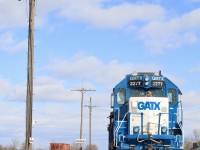 If this old telephone pole could talk, I can only imagine the stories it could tell. It has seen the transition from steam to diesel, the passage of countless trains, not just over CN's line but the once mighty double track Canada Southern that has since faded into history. Trains from not just CN but also Conrail, Penn Central, New York Central, CASO, Amtrak, CSX, Chessie System, C&O and Pere Marquette just to name a few have all hammered through the diamonds once located to the right of this old pole with its severed communication wires. It has out lasted both CN and CASO stations once located here as well as the old tower that once protected the junction. This day GMTX 2277 (a former Long Island RR GP38) rests with the rest of its consist briefly while its crew take a break in the new office after a run from Brantford. In a little while the power will take a cut of empty centre beams north to an industry north of town. 