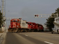  Other then motive power traveling to and from the OBRY this is the only time I have ever caught three units on T14 in all of my years of photographing the train. Reportedly 3022 had mechanical issues yesterday, and I couldn't think of a better unit to fill in for the occasion. With only a few painted SOO units left on CP's roster this was certainly a good reason to get out of bed early. These days T14 is often in Streetsville around 6am rather than late morning. While most of the former SOO GP38's are now equipped for remote control operation, it appears 4410 so far has not been RC equipped. The train has now finished switching in town and has just grabbed a cut of BNSF covered hopper left on the branch, that were lifted earlier on its way to Streetsville and will depart town as soon as train #651 passes.