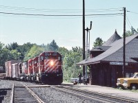 <br>
<br>
….Clear Board....and one of my favourite places...
<br>
<br>
...a quartet of six motor units: 6049 / 5513 / 5531 / 4566 rolls into Parry Sound preparing to spot the Van at the station to entrain personnel
<br>
<br>
  SD40-2  /  SD40  /  SD40  /  M630
<br>
<br>
 CP Rail #405 at Parry Sound 11:35 August 11 1985 Kodachrome by S. Danko
 <br>
<br>
  what's interesting
<br>
<br>
  always something going on at Parry Sound, whether it's daily VIA #9 & #10 ; a work train - witness the work train Van - and /or the signal / maintenance crew activity
<br>
<br>
  note the front end of  ' Parisienne Atlantica ' on the extreme right, of Newfoundland road trip fame...
<br>
<br>
  recommend camping at  nearby Oastler Lake Provincial Park, literally steps away from the CN and CP mains. Real treat overnight.....heard  of many campers abandoning their long weekend campsites Saturday mornings...'too many trains'....HA!
<br>
<br>
 more Parry Sound
<br>
<br>
<a href="http://www.railpictures.ca/?attachment_id= 13644">  anticipation at the station   </a>
 <br>
<br>
sdfourty
