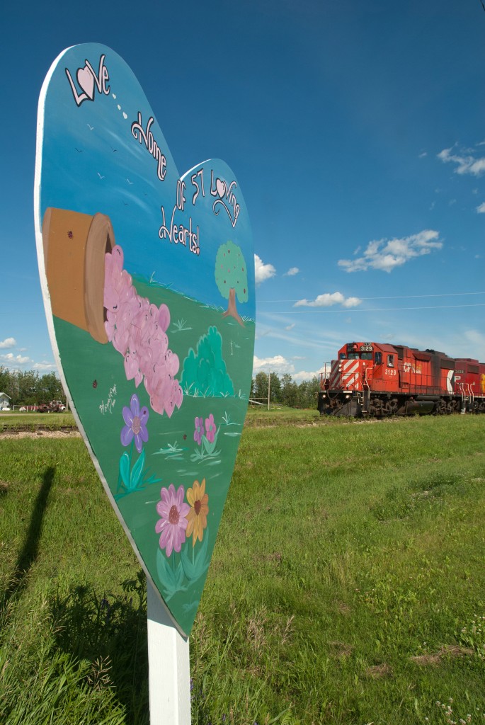 With grain empties bound for Choiceland SK, CP 3129 slowly trundles through the town of Love... "Home of 57 loving hearts".