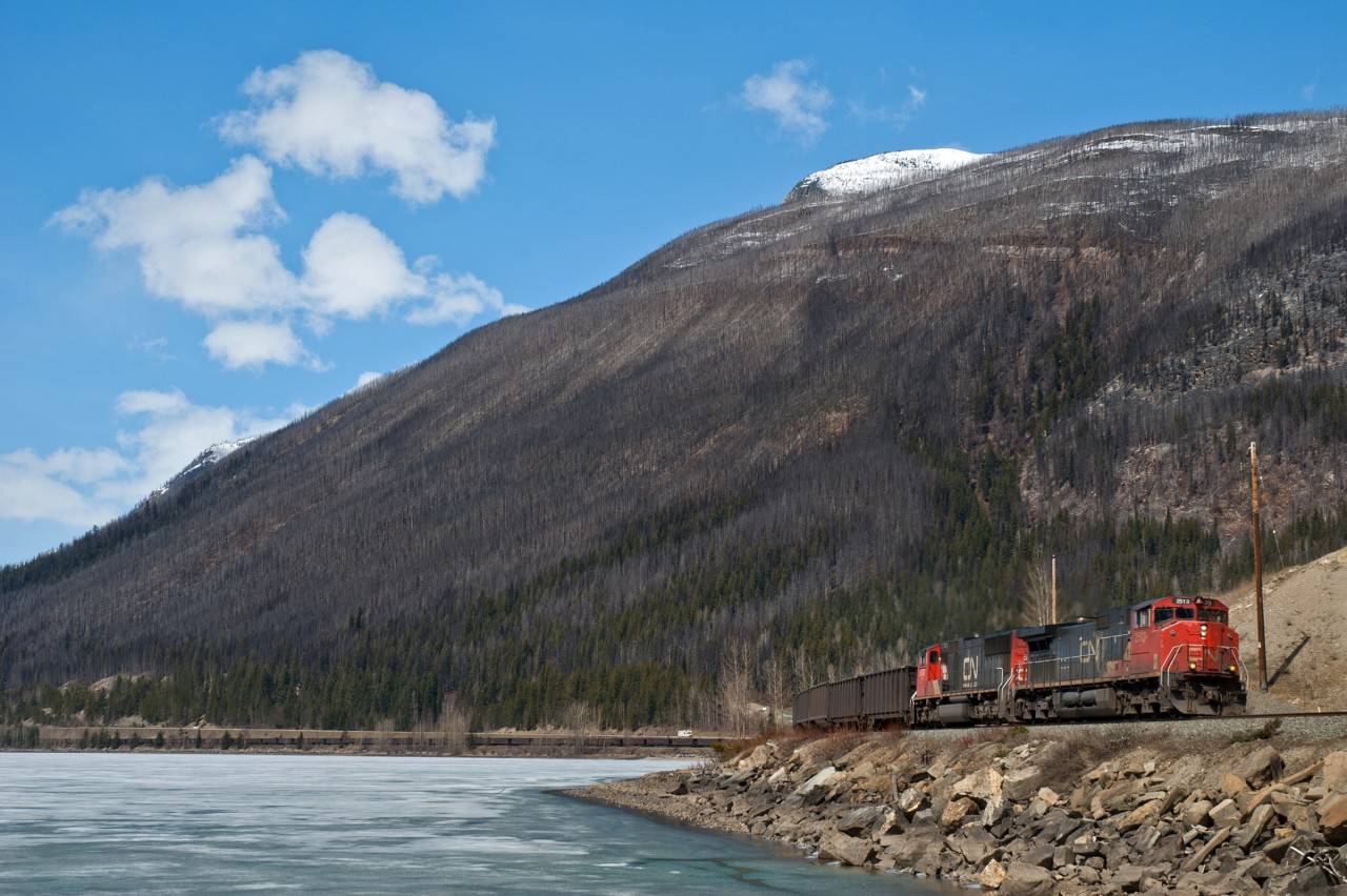 CN coal empties navigate around Moose Lake and are about to duck under Highway 16 as they make their way east towards Jasper for a crew change.