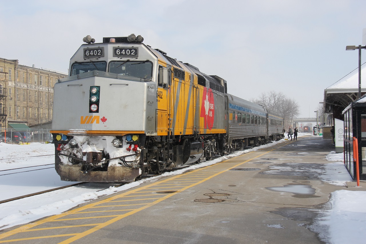 About a year ago, VIA 85 makes it's usual lunch time station stop at the Kitchener VIA Station as the last remaining passengers board. Notice that CN train 568 is waiting in the wings in the background.