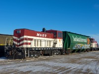 A pair of Mobil Grain's 70 tonners bracket a B/O grain car at the company's facility in Aylesbury Saskatchewan.  