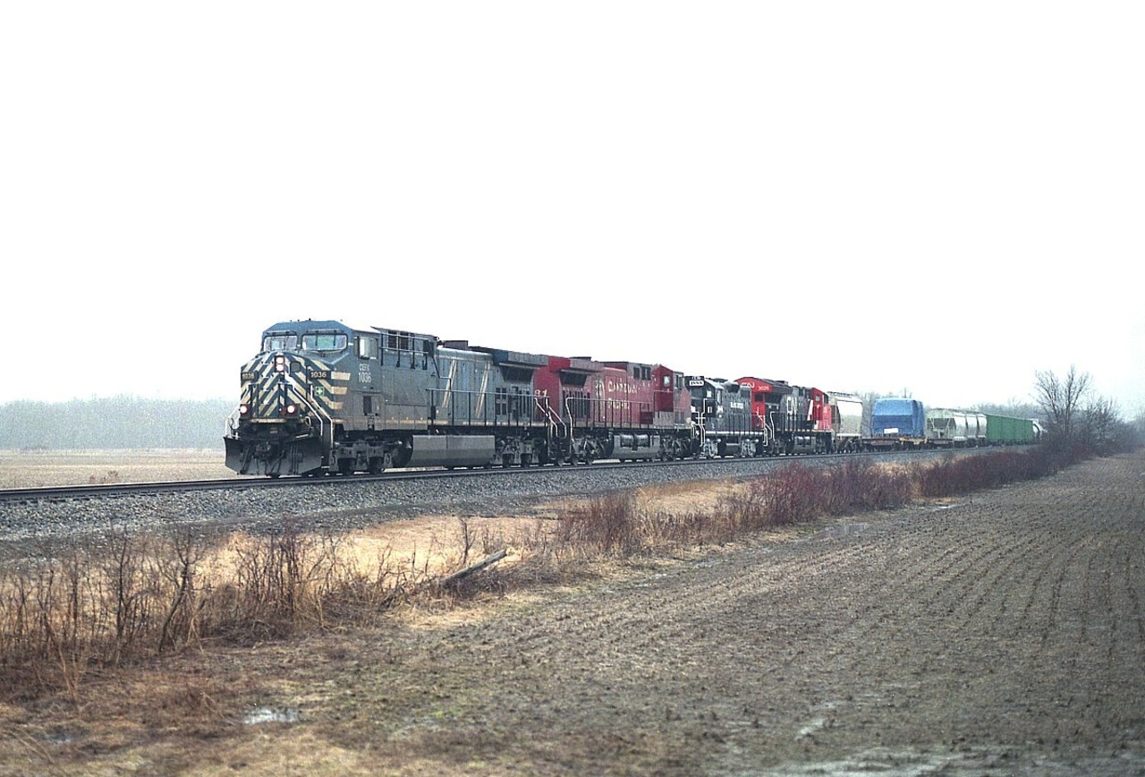 Running southward, halfway between Hamilton's Kinnear Yd and Welland, train #246 is about to cross Grimsby Rd 10. Of course it is one of the ugliest of ugly days, I keep insisting (for me) that is when the most interesting trains run. Failing that, in the night. This day was brutal. But, in a way, so was the train. :o) Despite it all, a lashup such as this, CEFX 1036, CP 9681, BR&W 1888 and CN 3026 was worth the catch.
The BRW is Black River and Western. Why it was along, I do not know. Unit on the way home to New Jersey.