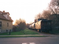 Spring has taken hold as the 15:30 Kitchener Job slowly makes its way through the neighbourhoods of Waterloo. CN 4134 and three hoppers are destined for Elmira on the Waterloo Spur with caboose 79443 on the tail-end. The train has just crossed John Street as they into a vibrant spring sunset and towards Uptown Waterloo. 