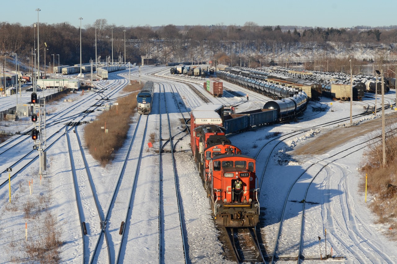 Driving up the hill toward Stuart Street seeing the GMD1 in lead working Hamilton was something you need to stop for even with the -20 degree lake winds just completely taking over your body. They headed to the west end of the yard to spot some tank cars on a cut that needed to be lifted, came back to the east end here at Stuart street then headed back into the yard. 10 minutes passed and they still don’t pull up to a point where it’s shootable and was making me confused as I didn’t want to wait in this cold much longer as I couldn’t feel my upper body. Just then they pull a cut of cars out of the yard and start to proceed to the main track for headroom when VIA 97 the VIA operated inner Canada Amtrak train flies around the corner pacing this yard job’s train as it pulls out. Will they be side by side? No, unfortunately 1437’s nose ducked under the bridge before the Maple Leaf got closer into the main frame of the shot but what do ya do. Still a cool scene to see Canada only operated GMD1’s with Amtrak equipment in the background. With the perfect sun light to, the last thing I’d do is complain.