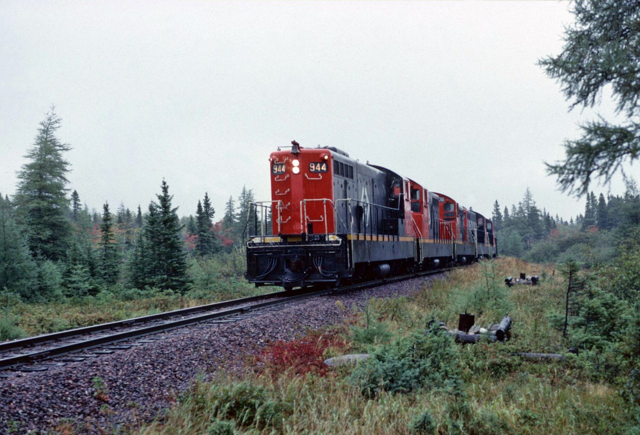 Riding the last official train east from Bishops Falls to St Johns was probably the most emotional trip I have ever ridden.  Careers were coming to an end, a cross province link was being broken and a way of life was terminating. While 944E made its way east in pouring rain, Engineman M Greening suggested we should at least get a video run-by and photo at a curve he thought would be perfect. A couple of miles ahead, he stopped, let me off, backed up and came forward for the "runpast". So typical of Newfie friendliness.  I made many new friends those last few days and even re-visited some years later.