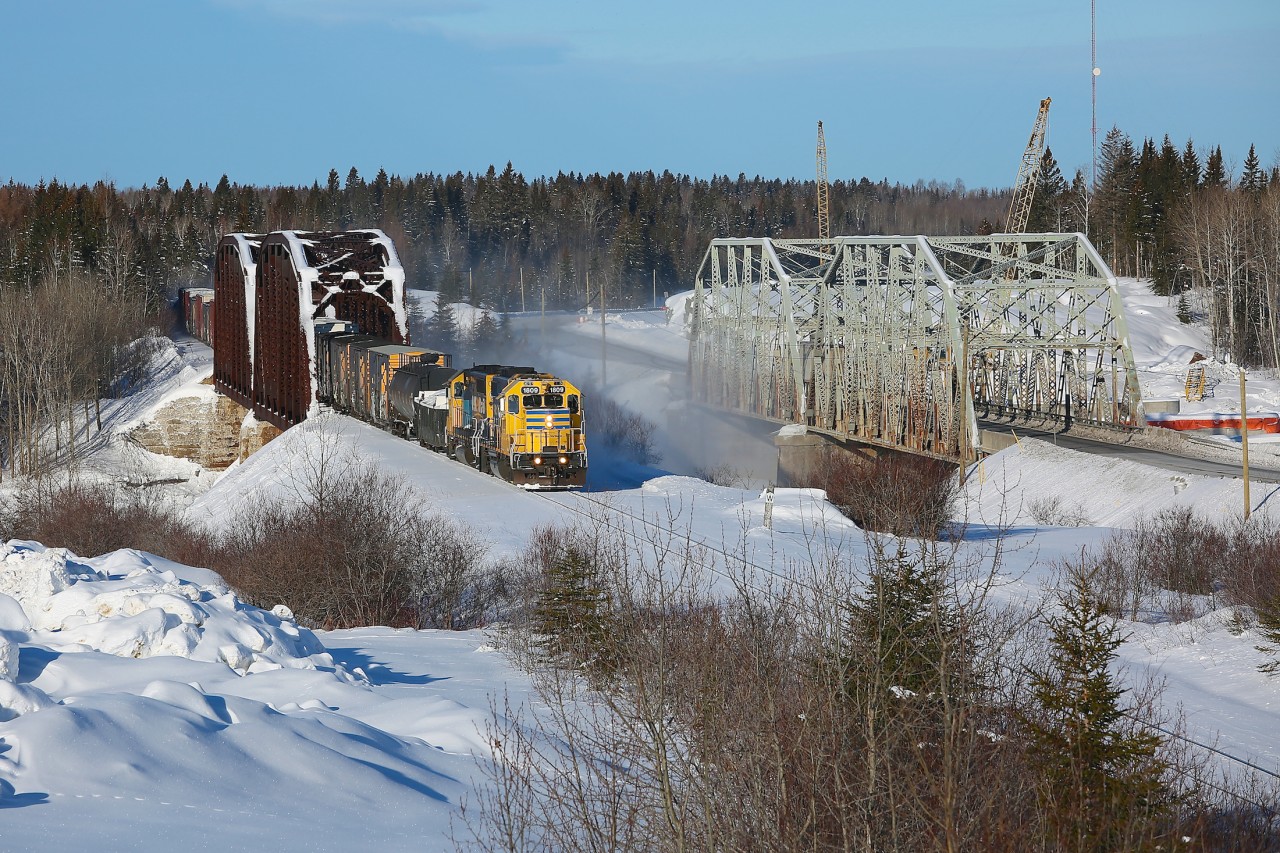 The Hearst to Cochrane triweekly train makes its way across the Groundhog River west of Fauquier.  514 departed Hearst shortly after 0600 with 22 cars and subsequently lifted an additional 16 in Kapuskasing before continuing eastwards.  It's a fun chase as the train is limited to around 30km/hr and there are many interesting bridges and small towns that the railway passes through.  As seen beside the railway, Highway 11 also passes over the Groundhog River via a two-span steel truss bridge and work is well under way to replace this aging 80 year old structure.  The piers and headers of the new bridge can been seen on the far right.
