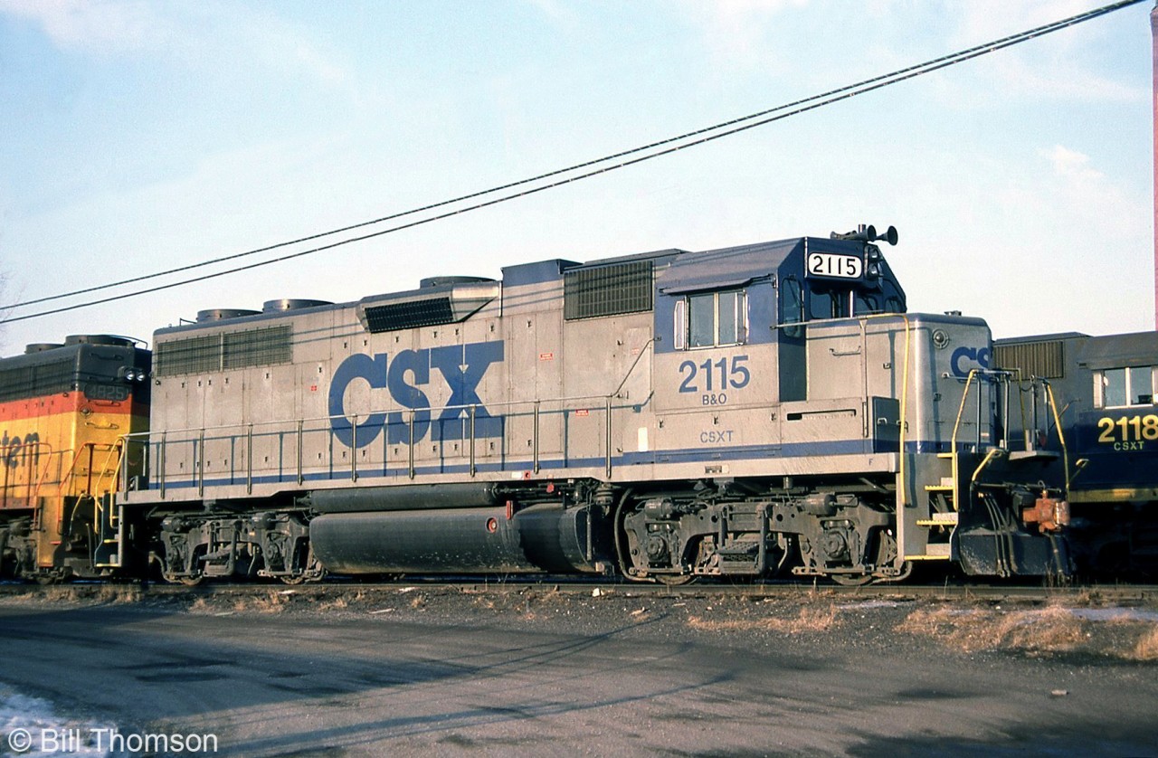 CSXT / B&O GP38 2115 sports one of the early versions of CSX's paint scheme, seen at St. Thomas in October 1987. This "CSX stripe scheme" livery featured only grey and blue paint, and debuted in the mid-80's. Yellow ends would soon be added to later repaints. Note that this unit, originally built at B&O 4815, is stenciled for both B&O and CSXT on the cab.