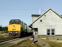 Via's eastbound "Chaleur" pulls into the station at Barachois, while someone waits for an detraining passenger