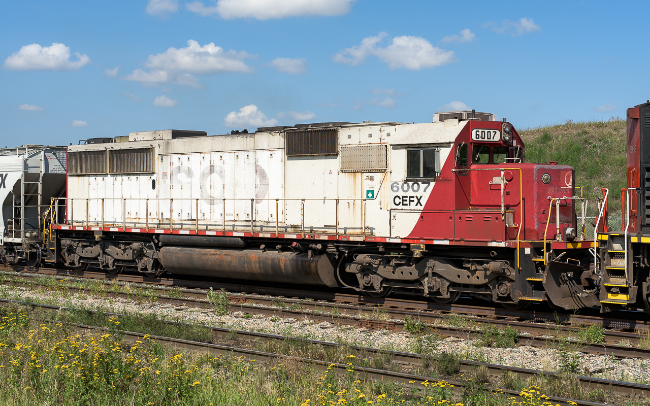 The one instance of a SOO paint job I have seen on my outings in south Edmonton. Take your pick of the 3 visible company designations. You have to zoom close on my original to see the remnant of circle with the I on the side of the unit from the INRD. The SOO and INRD do a nice overlap on the nose. Whatever the paint scheme, I do like the SD60 model.