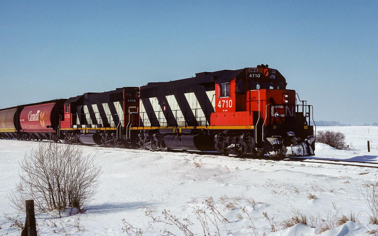 A photo to go with Jamie Knotts recent post of the 4710. Here it is 29.7 years earlier. Not many changes in all that time. The yellow reflective stripe has been changed, electric bell replaces the mechanical, horn has been moved, some placards along the frame edge have gone and the paint has weathered. I snapped a few good pictures of this unit in the summer of 1986 in the black noodle scheme with original number 5510. Checking further in my notes, the first time I saw it freshly painted in zebra stripes was Feb.24th, 1987. My last sighting of it as the 5510 was June 18th, 1988. This photo is my initial sighting of it as the 4710. On this day it is taking loaded tanks to the airforce base and a few grain cars to be peddled along the way, cab 79836 is on the tailend. The 4708 is trailing, photo taken at 11:45.