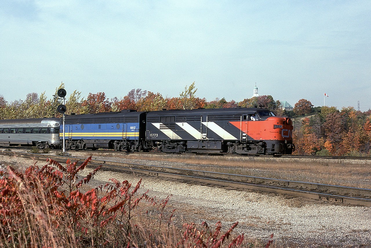 Mid afternoon wandering at Hamilton West, caught off guard by the passenger coming thru. I guess the noise from the Hwy 403 close by distracted me. But the fact it was a nice day gave me a pleasing photo.  We are just at the infancy of VIA at this time, hence the CN 6773 leader and the B unit, 6617, already done up in the new corporate colours.
I've forgotten the series in which that first car is an example of. Someone enlighten me? Thanks.