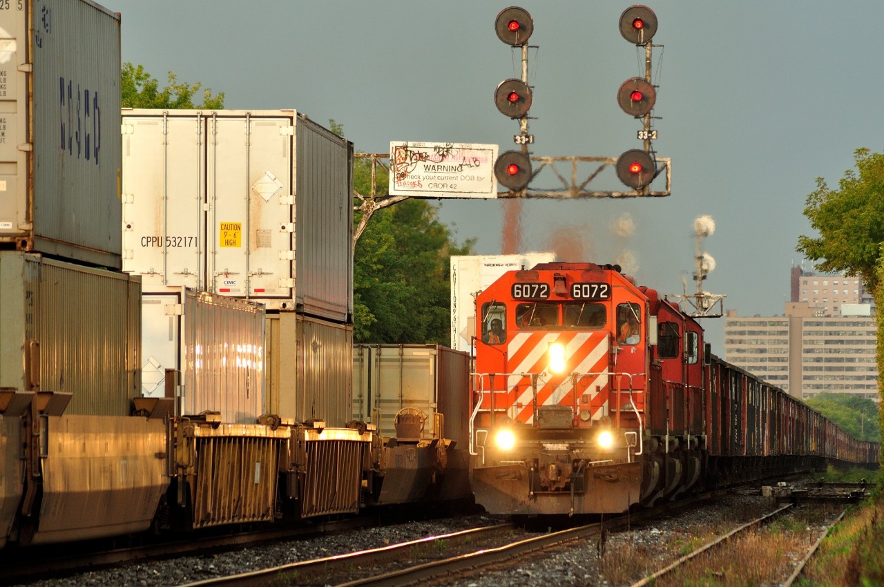 An EB rock train passes a WB stack train at Spadina Avenue on CP's North Toronto line, 9/14/12.