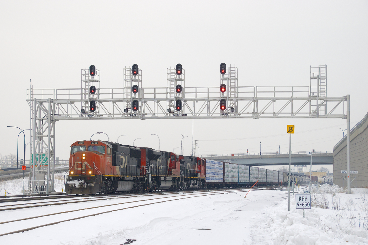 CN 324 with CN 5700, CN 8007, BCOL 4647 and 80 cars is ducking under a signal bridge at Turcot Ouest, on its way to St. Albans, Vermont where it will interchange with the New England Central Railroad.