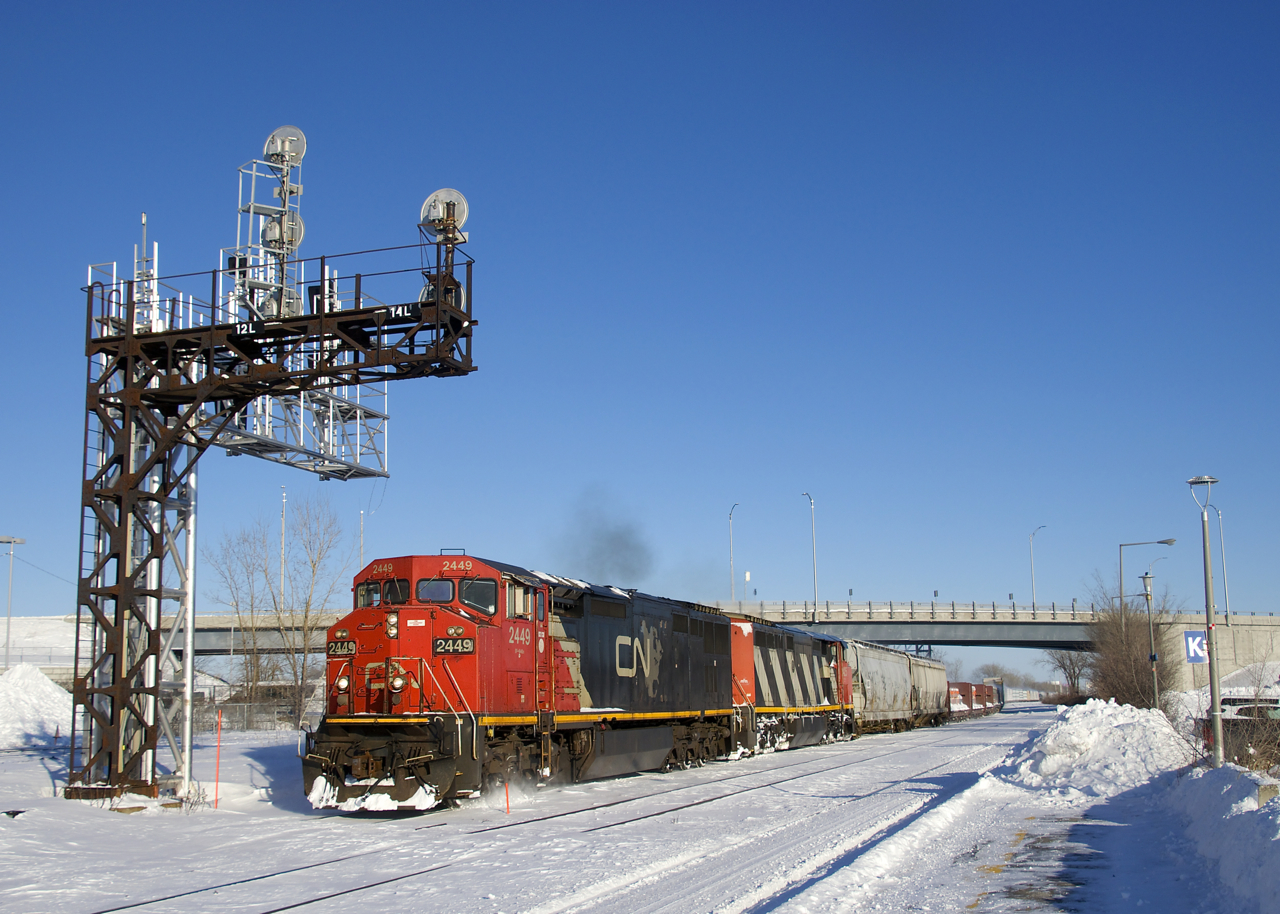CN 2449 & CN 2445 lead a 125-car CN 373 through Dorval on a sunny and cold afternoon.