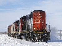 CN 522 with CN 9410, CN 9523 and 3 cars kicks up the snow on its way to switching a couple of clients in and near Saint-Jean-sur-Richelieu.