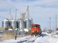 CN 522 is doing switching at Nova Grain, situated just off the Rouses Point Sub in Saint-Jean-sur-Richelieu. CN 9410 is at the front of a cut of cars, and CN 9523 is out of sight at the other end.