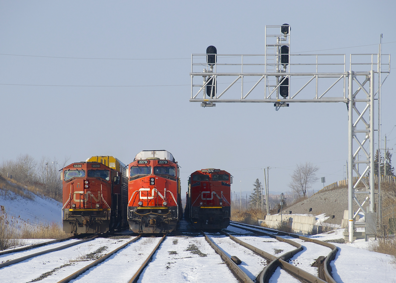 A trio of trains are parked just east of Belleville Yard (M37231 07, M30631 06, and M37631 06, all have since been given new ID's) and have been stuck here over two weeks now due to a protest on CN's main line along Tyendinaga Mohawk territory, which has seen both freight and passenger trains unable to use CN's busy Kingston Sub at a point a bit east of here.