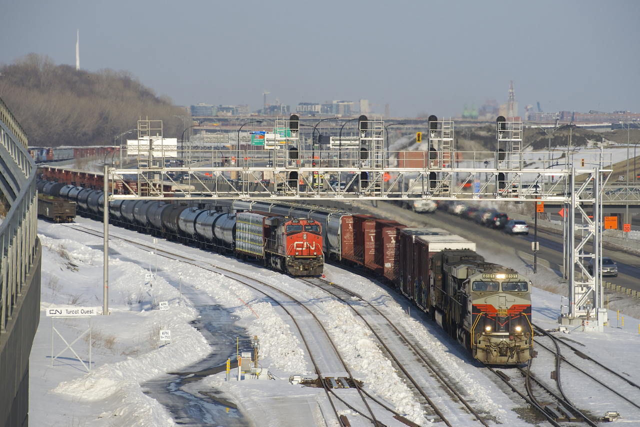 A rare daylight CN 529 has heritage unit NS 8101 leading (and NS 9709 trailing) and a decent sized train as it passes a CN 305 that has been parked at Turcot Ouest over two weeks now due to a protest on CN's main line along Tyendinaga Mohawk territory.
