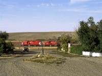 The Town Pump.  Westbound grain tramp from Assiniboia to Mankota passes the town pump in the almost ghost town of Fir Mountain in southwest Saskatchewan's cowboy country