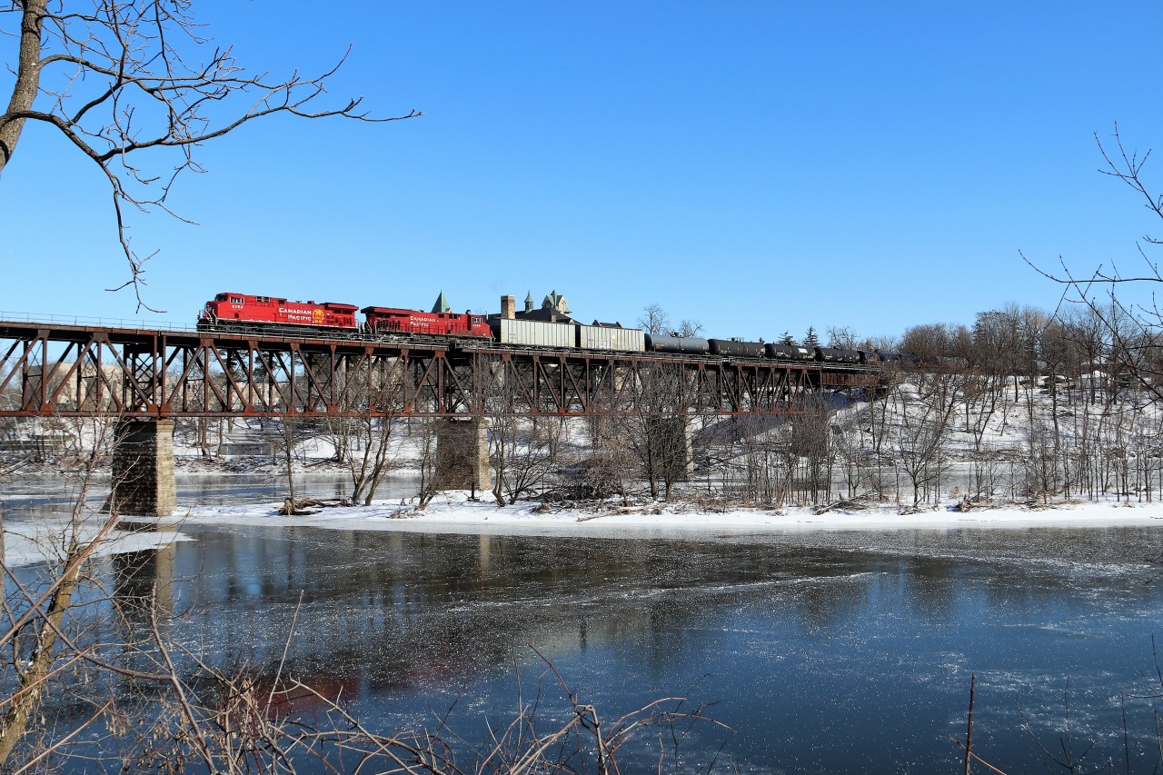 After making a detour up the Hamilton sub, CP 651 with CP 8153 and CP 9369 make their way over the Grand River bridge on the way west for a meet with T72 at Orrs Lake. Believe me when I say, it was real cold standing on a snow bank for 30 minutes in -20C weather and the frozen river adds to the shot.