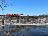 After making a detour up the Hamilton sub, CP 651 with CP 8153 and CP 9369 make their way over the Grand River bridge on the way west for a meet with T72 at Orrs Lake. Believe me when I say, it was real cold standing on a snow bank for 30 minutes in -20C weather and the frozen river adds to the shot.