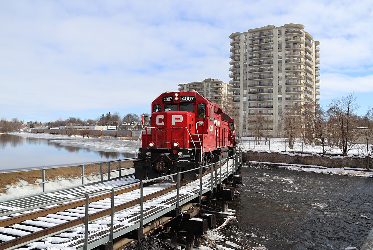 I have heard this train on the scanner for a few months running the Pender to Wolverton job but in the last week it has swapped over to T72.  Former MILW 2066 and SOO 2066, GP40-3, CP 4007 leads a 3200 foot auto rack train across the bridge by the dammed up Speed River on its way to the Toyota plant. Oddly enough this train would go in to emergency about 100 feet up the tracks and was a cold wait to get back to my truck on the other side.