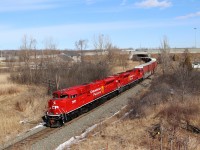 Two beautiful freshly painted red barns glide down the Hamilton sub and appear from under the Highway 403 bridge as they head south approaching the Newman Road overpass on there way south for a stop at Kinnear.
CP 7027 and CP 7008 provide the power.