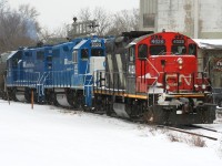 CN train L568 with 4028, GMTX 2323 and GMTX 2279 crosses Queen Street in Kitchener on the Huron Park Spur with hoppers for the interchange with Canadian Pacific during a frigid snowy afternoon. 