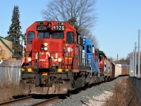 CN L540 is approaching Ottawa Street in Kitchener on the Huron Park Spur in early morning light. This location can be a tough crossing to photograph due to all the tightness of the tracks and the sun angles. Ideally you need a morning train as the sun will be on the more open side as seen here, which can be a further challenge as L540 infrequently ventures down the spur at this time of day. However on this Saturday morning everything seemed to come together. Powering the train are 4726, GMTX 2255 and 4761. GP38-2 4726, with its unique number-board, was set-off by the previous night’s A431. L540 would set-off all its cars at the interchange with Canadian Pacific and return light power back to the Kitchener yard. 