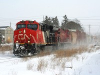 On Friday morning I awoke to the news that CN 533 had died the previous night in Kitchener and the trailing unit was CP 8616. While that was pretty historic in itself, I had to head to work in Baden, which is situated just west of Kitchener, with thoughts of taking a bit of an extended lunch and hopefully maybe catching the power laying over if it was still there. That plan went out the window rather quickly as it was determined that CN L540 would take the two GE's and a block of cars west to Stratford to lessen the congestion in a full yard at Kitchener. While it was rare enough for CN L540 to venture west of Kitchener,
it was even more layered as it would take 533's power, with one unit being CP 8616. Luckily I'm fortunate as my boss understood that I needed to take an extended break to witness a bit of history on the Guelph Subdivision. So during a brief lull between snow squalls, CN L540 is seen crossing Mill Street in Baden as it heads west to Stratford powered by CN 3143 and CP 8616. 