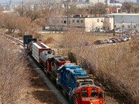 This is a spot that I have never had luck at shooting till today, usually the sun is in a bad spot or the vegetation shadows out the train. As luck would have it the local had just finished working the deep industrial jungle in Hamilton just after the passage of train 422 so I was finally in the right location at the right time. Today's consist was a good mix of EMD units in the form of a GP9RM, GP38-2 and GP40-2. A mix of industries and the QEW Burlington Skyway bridge can be seen in the distance.
