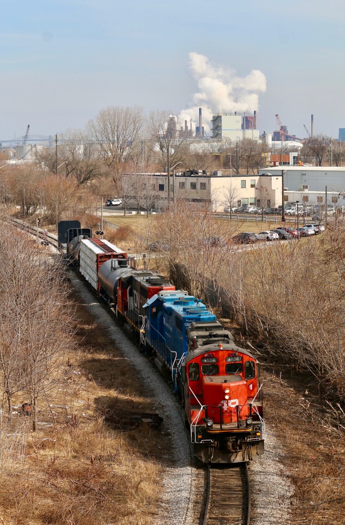 This is a spot that I have never had luck at shooting till today, usually the sun is in a bad spot or the vegetation shadows out the train. As luck would have it the local had just finished working the deep industrial jungle in Hamilton just after the passage of train 422 so I was finally in the right location at the right time. Today's consist was a good mix of EMD units in the form of a GP9RM, GP38-2 and GP40-2. A mix of industries and the QEW Burlington Skyway bridge can be seen in the distance.