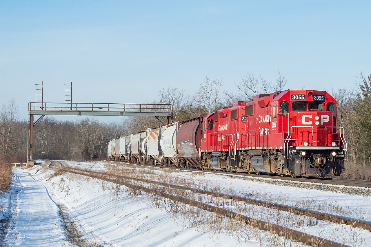 TE11 has just set out from Welland Yard, with the typical transfer traffic in tow for CN and Trillium. Their first stop is typically Feeder Yard for Trillium, and they access it by pulling ahead off the Hamilton Sub onto Rusholme Siding, and then shoving down the Trillium Cayuga Spur (pictured in the foreground). The head end traffic pictured is all traffic being returned to CN at Southern Yard. The first two hoppers are empties from Washington Mills in Niagara Falls, and one of those maroon/burgandy (I am not good at colours) 3800 cu.ft. CN hoppers is fairly typical for Washington Mills traffic. The following six hoppers and two black and white tanks are from Innophos in Port Maitland, and also heading to CN at Southern Yard. TE21 serves both Washington Mills and Innophos twice weekly at night. I shot this TE11 on its return from Southern Yard as well, on the CN Stamford Sub.