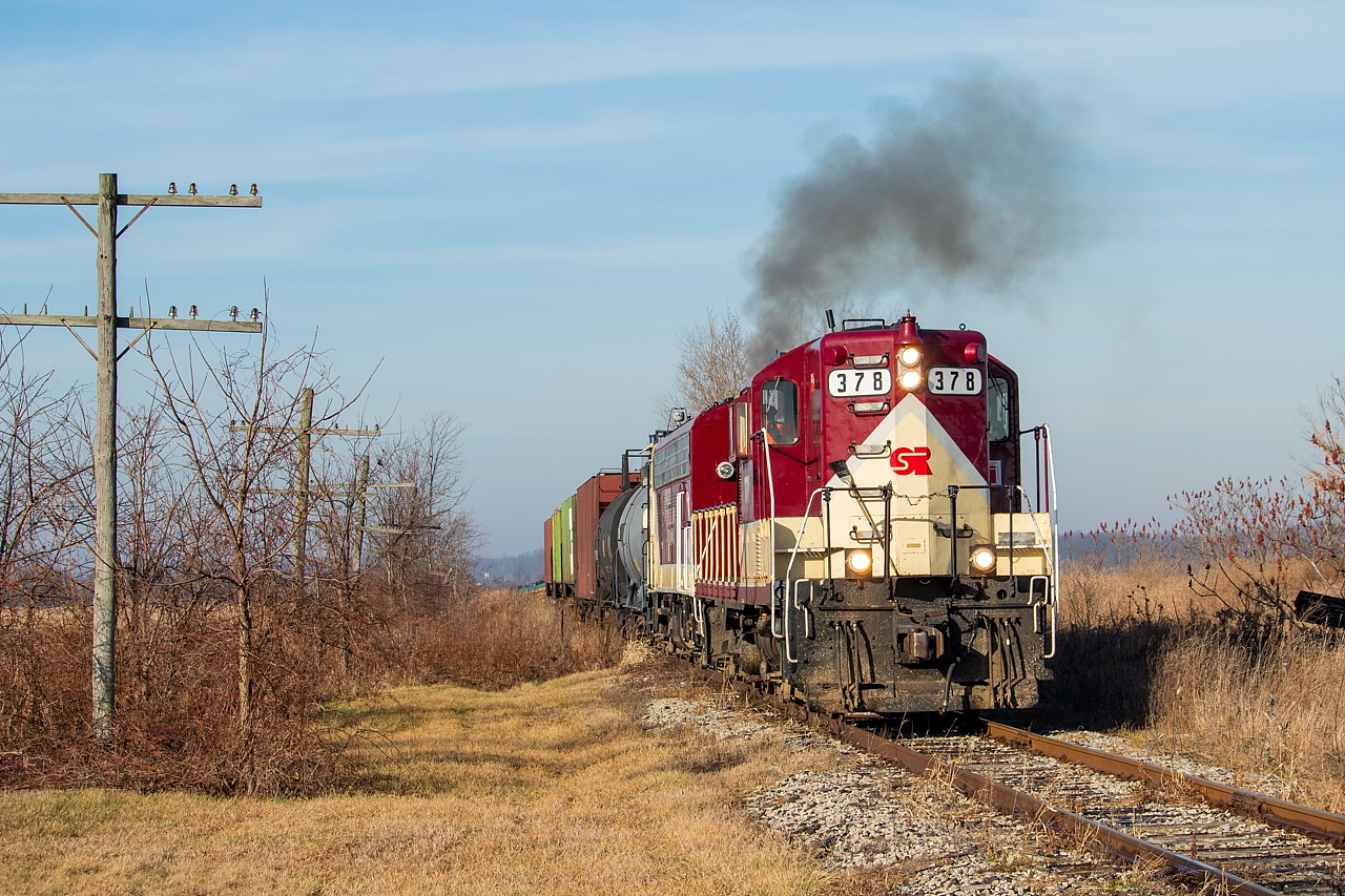 With the crossing having activated, the hogger kicks it back up a little causing 1401 to respond with a bit of smoke. The 378 wasn't loading on this day, so 1401 was working on its own for this Cayuga Clipper, as it proceeded eastward towards Aylmer, Tillsonburg, and Courtland.