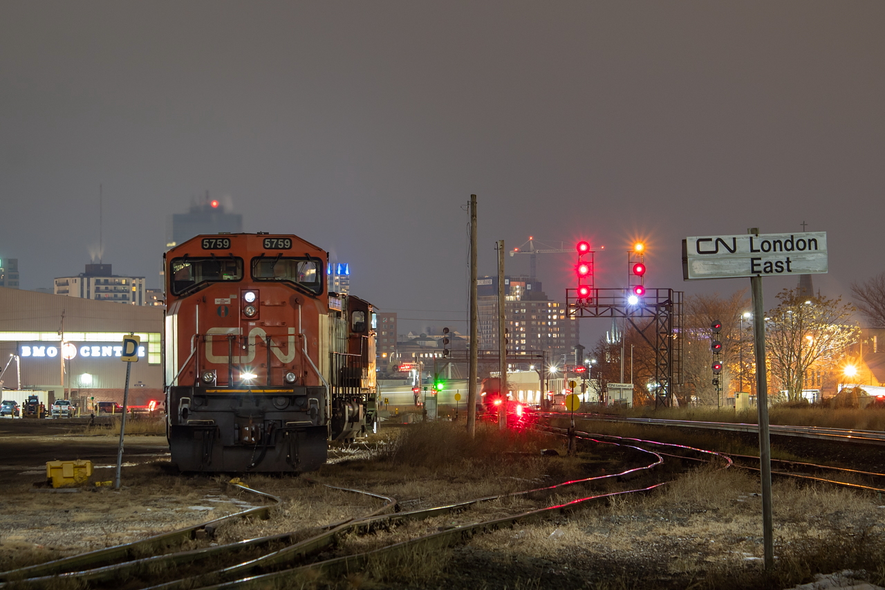 The power for 435 is tied down in London Yard, waiting to become the following day's 509 to Sarnia and back, and later 434 on the return trip to Mac. In the background you can see the blur of 583 shoving back to yard their train, with a good string of cement hoppers from Stubbe's in Princeton on the tail end.