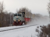 After setting off a defective car, eastbound CP freight #142 departed Smiths Falls at 1430 hrs on Sunday, February 9, 2020. From where I was standing on McCrea Road, seven miles away, the sound of the train throttling up echoed like thunder.

The train is led by "HMCS" CP 7022, assisted by mid-train DPU 8723 and rear DPU 8548. The three units had 142 up to the 50 mph track speed when it hit mile 116 at 1437 hrs. The grey of the lead unit and the vortex of snow enveloping the train are great camouflage for the gloomy overcast day, typical of winter in Eastern Ontario.

Scenes like this will change soon. The Winchester Subdivision is currently directional double track with OCS/ABS, but it is slated to be converted to single track CTC. New "Darth Vader" shrouded LED signals are being positioned beside some of the classic ABS searchlights, and track removal is likely to start in May.
