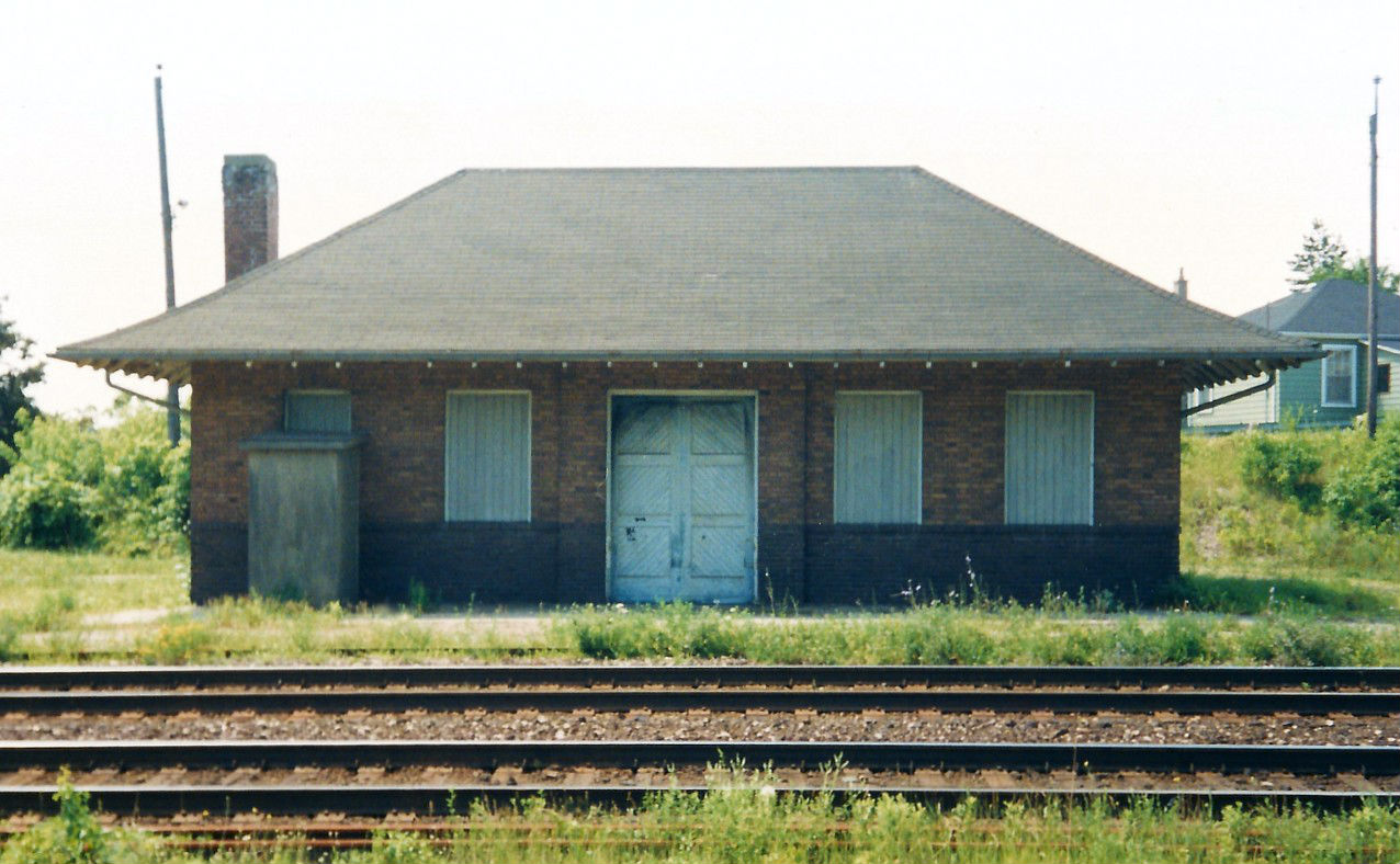 My dad and I would usually venture to the town of Pairs on either Saturday or Sunday mornings to check out the action on the CN Dundas Subdivision. You were always guaranteed some trains that could range from the intermodal “Lasers” 238 and 239, as well as 380, 381, 410 and 411. Trains 380 and 381 ran between Toronto and Windsor, while 410 and 411 operated between Toronto and Sarnia. Also, you would have the usual morning VIA trains as well as occasionally a local from Hamilton that ran to the pit in Paris. I’m assuming on this morning, the signals around town were all red so we ventured down to where the second train station had once stood. Long since torn down, the only thing that remained was the CN express building that was now used for storage at the time. The problem with where the building was situated was that the front of it was never really in good lighting, only maybe at certain points during the longer days of the year. However, at the time I was just fairly new to the hobby so lighting and sun positioning hadn’t really factored into my photography decisions. If it had, I probably never would have taken the photo seeing as how I was shooting more or less in the direction of the sun and on a backlit subject. In the years that followed I don’t believe I ever took another stand-alone photo of the building, only just including it in frames of trains going by. Then one day we went back and it was gone.