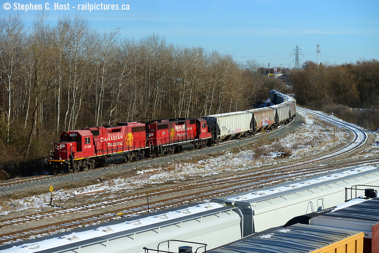 The CPR Waterloo subdivision runs 10 miles from Galt to Kitchener and T97, a local based out of Hagey yard in Cambridge (about 4 rail miles south) is arriving at the CN/CP interchange yard in Kitchener with cars of agricultural products. A lot of GEXR's CP cars come through this interchange as far as I can tell. What was nice about this is the pair of matching Beaver paint schemes introduced in 1997  See Jason Noe's photo here of the introduction train  which were ubiquitous in the early to mid 2000's are becoming rarer and rarer - except now being re-introduced on the rebuilds out of Progress and Wabtec. I enjoyed this scheme  am glad it's coming back - but these two really look worse for wear.
History notes: This track pictured was put into service on 1 October 1961 for the re-alignment of the then Electric Grand River Railway. The new Highway 8 was built on some of their old alignment and instead of electrifying the new railway the decision was made to dieselize which happened on the same day. A deal was reached with the CNR to share the Huron Park spur (Then CNR Waterloo subdivision) between South Junction and North Junction where the CPR got back onto their own rails to Waterloo on the rest of the Grand River Railway. Just north of here is still known as South Junction where CPR gets onto CN rails to switch the interchange yard and the CPR can be found as far north as the highway underpass. The Waterloo sub north of South Junction was abandoned on 31 July 1993. (Source: Steel Wheels along the Grand, George W. Roth - was sold at Credit Valley Railway - copies may still be available)